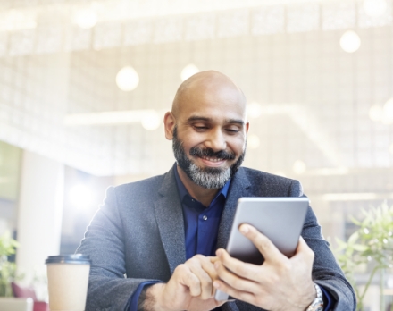 Businessman viewing his phone and smiling