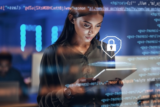 Young woman reading an ipad, superimposed image of a shield with a lock in side it, code reflection