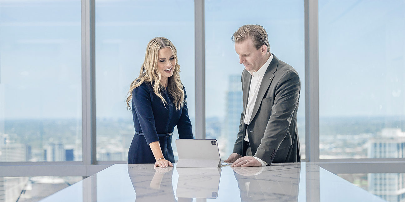 Two people looking at an iPad