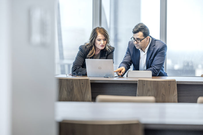 Man and woman looking at a laptop